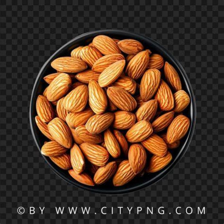 almonds in a black bowl against dark rustic wooden background