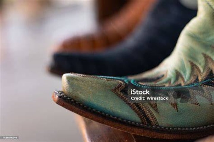 Close-up of a boot and spur on a policeman riding a horse