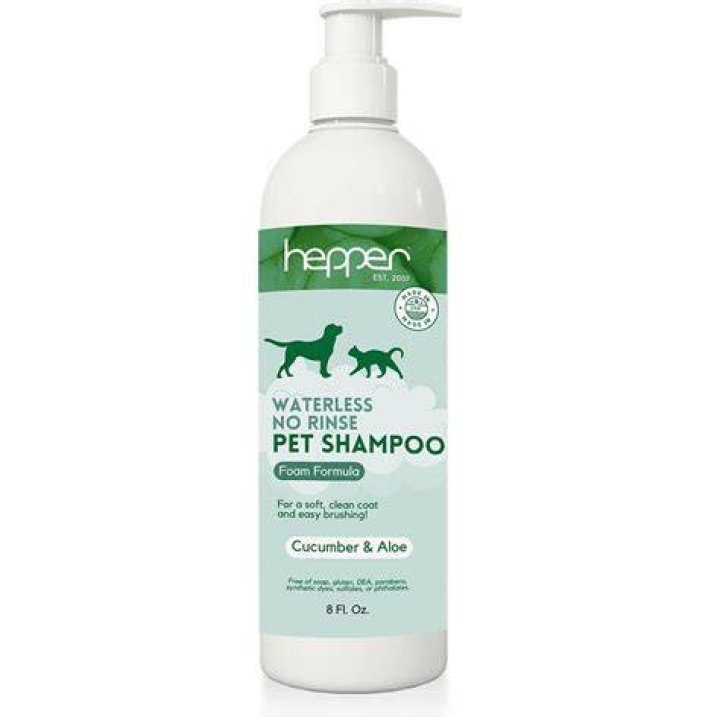 Dog + Hepper waterless dry shampoo sitting on towels