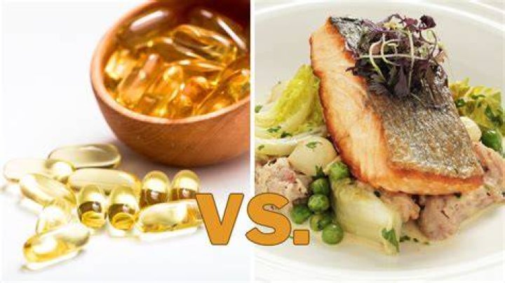 Doctor holding mackerel and Cod Liver oil tablets, close-up, mid section fish oil vs eating fish