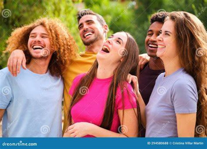 Laughing friends hanging out together during backyard dinner party laughing friends hanging out together during backyard dinner party