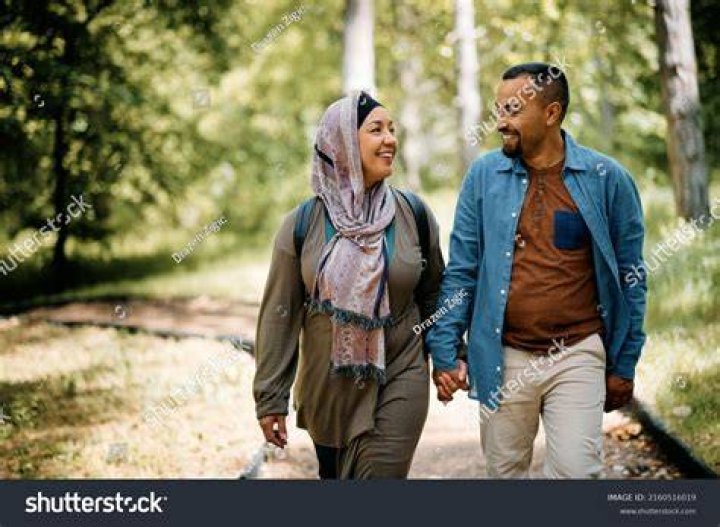 High angle view of business people ascending spiral stairway man and woman walking curve