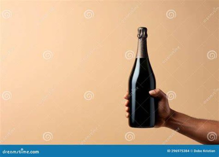 Man hand hold bottle to show fish oil pills man hand hold bottle to show fish oil pills on white plate vintage tone