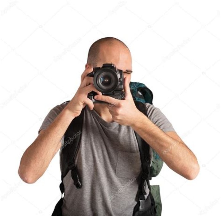 Man taking photos of a mountainous landscape