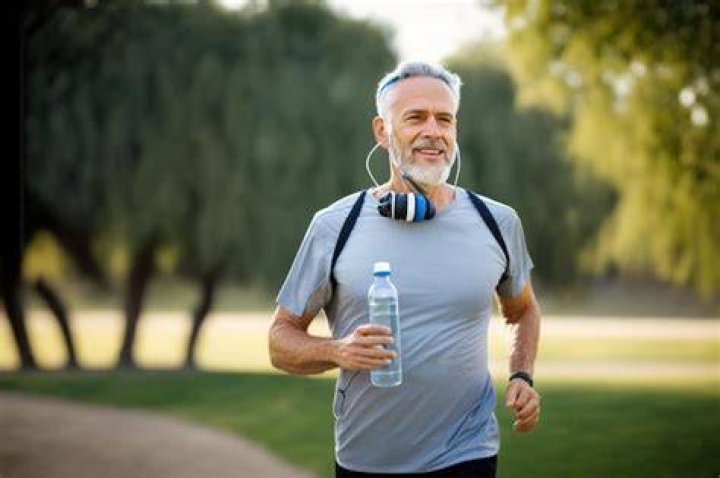 Mature athlete man doing exercise with weights in gym Mature athlete man doing exercise with weights in gym