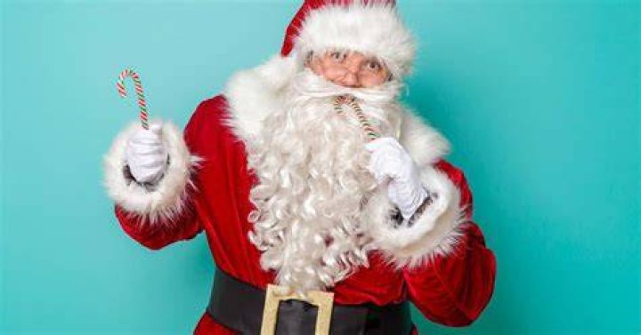 Santa handing out candy canes to Glenn Coco