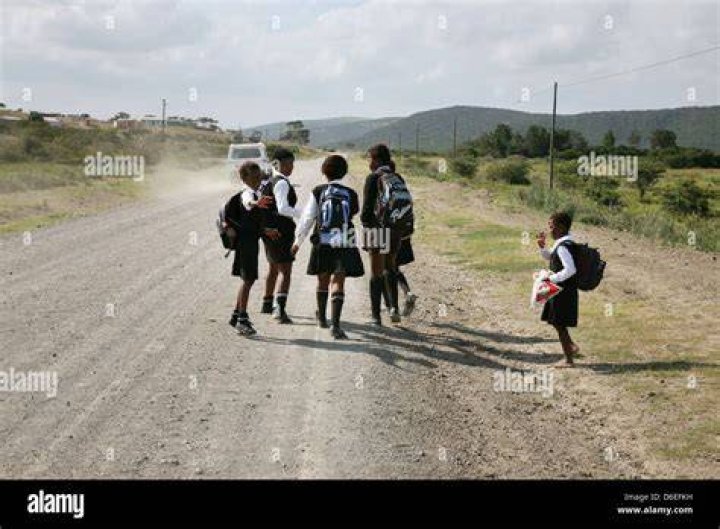 school children on dirt road