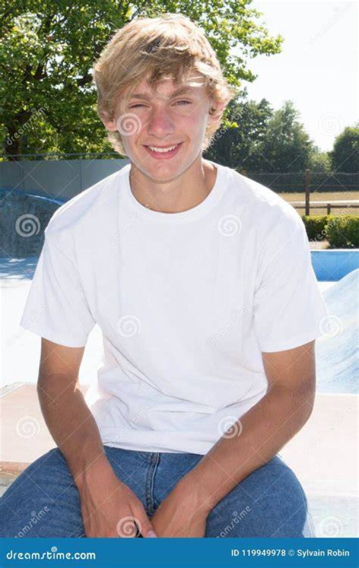 Teen boy smiling and looking away from camera