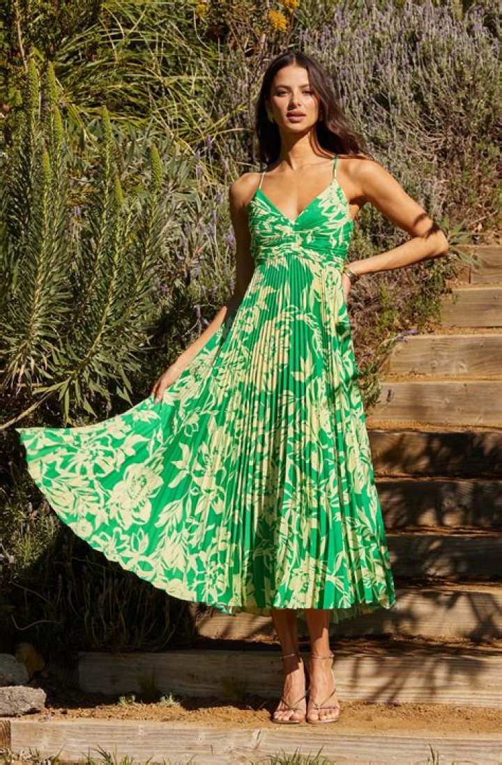 woman wearing astr the label gaia strappy bias cut satin midi dress with one hand on hip