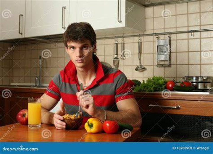 young man eating with his friends on a restaurant